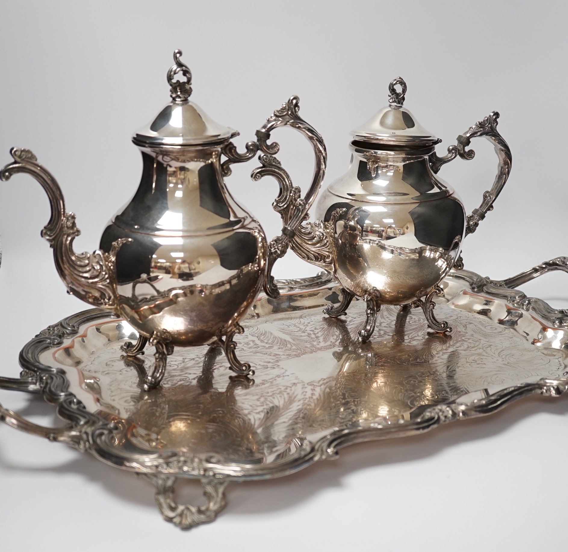 A silver plated two handled tray, a coffee and a teapot, tray 64cm wide